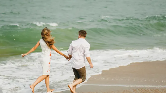 Couple running together on the beach